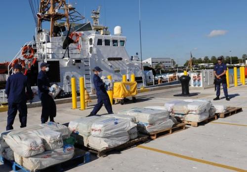 Crewmembers off-load 2500 lbs of cocaine from Coast Guard Cutter Sitkinak. Photo by Petty Officer 1st Class Crystalynn Kneen