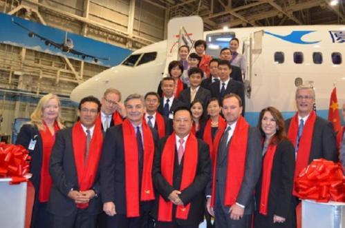 Executives from Boeing and Xiamen Airlines celebrate the delivery of Xiamen Airlines' 100th airplane