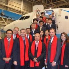 Executives from Boeing and Xiamen Airlines celebrate the delivery of Xiamen Airlines' 100th airplane